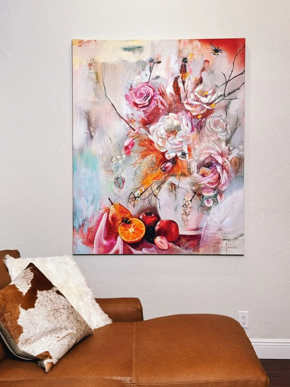 Painting of a feast of color, fruit, and creatures around a girl