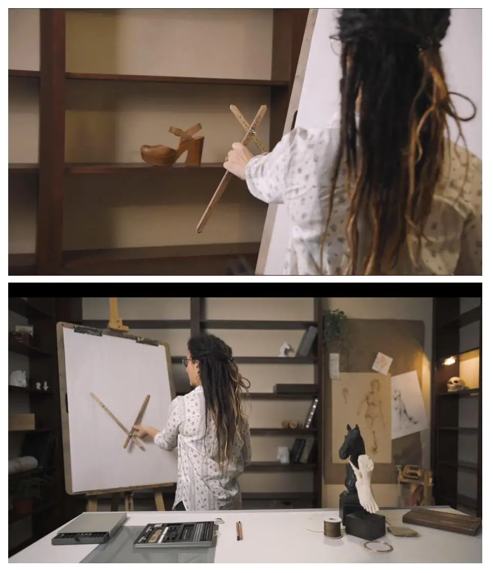 Artist measuring a shoe with a proportional divider to transfer proportions to a larger drawing
