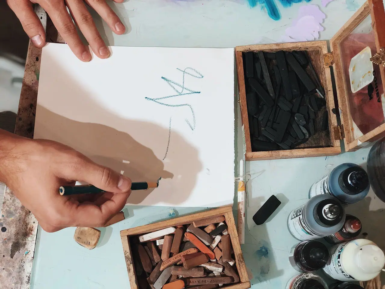 Hand scribbling fake writing marks in earth tones on paper