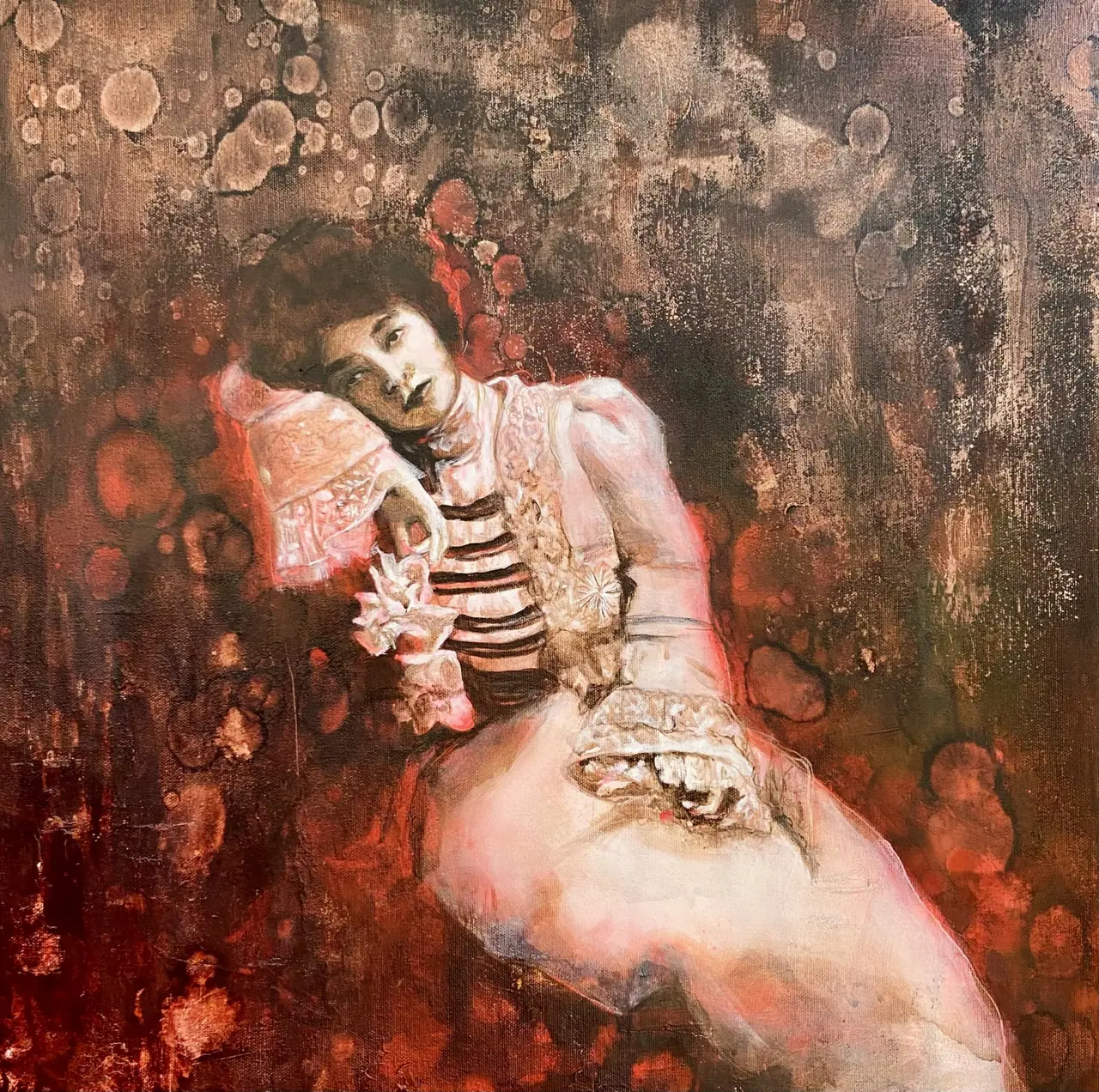 Painting of a woman seated in a pink dress against a maroon red background