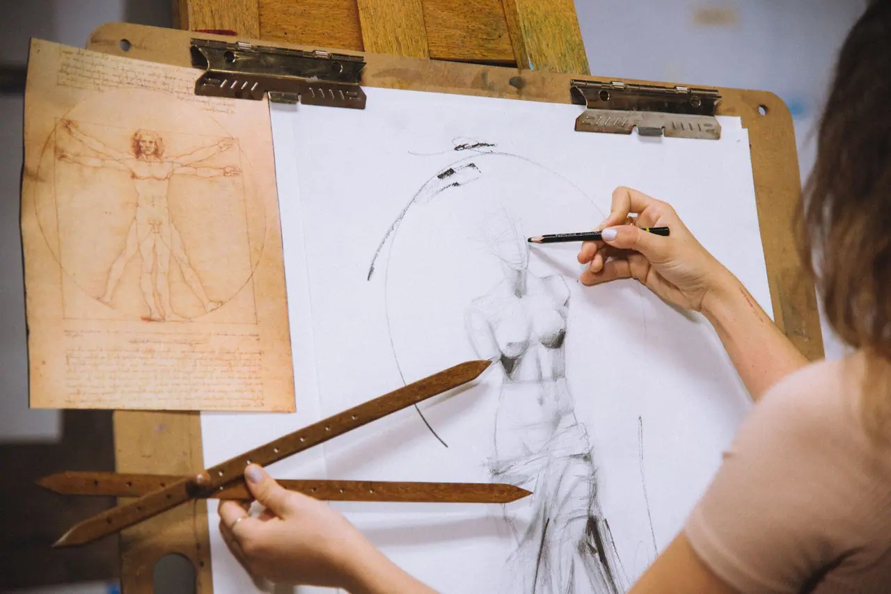 Artist measuring proportions from a statue with a proportion tool while drawing