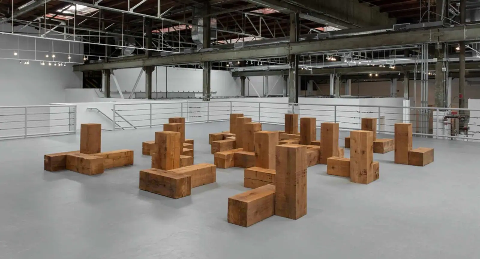 Carl Andre floor sculpture made of repeated identical metal plates arranged in a grid on a gallery floor