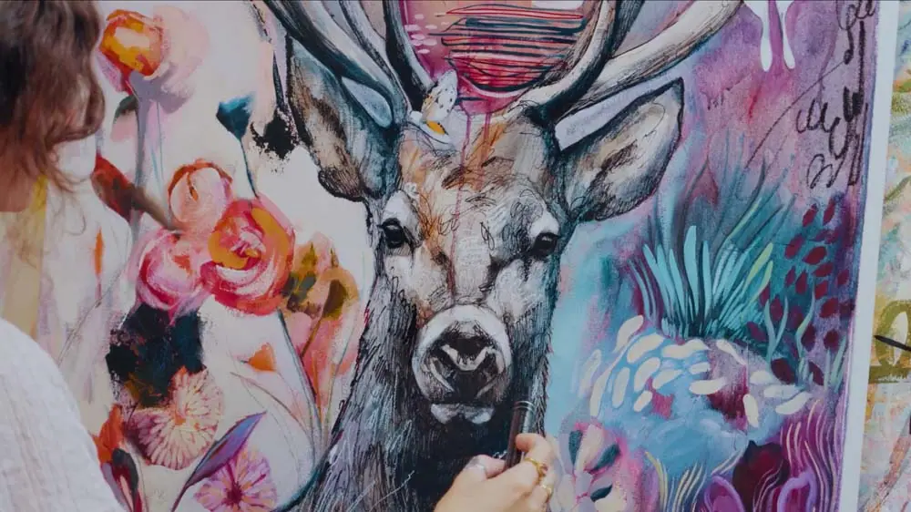 Expressive mark-making on a painting of a deer in blue, purple, yellow, and red
