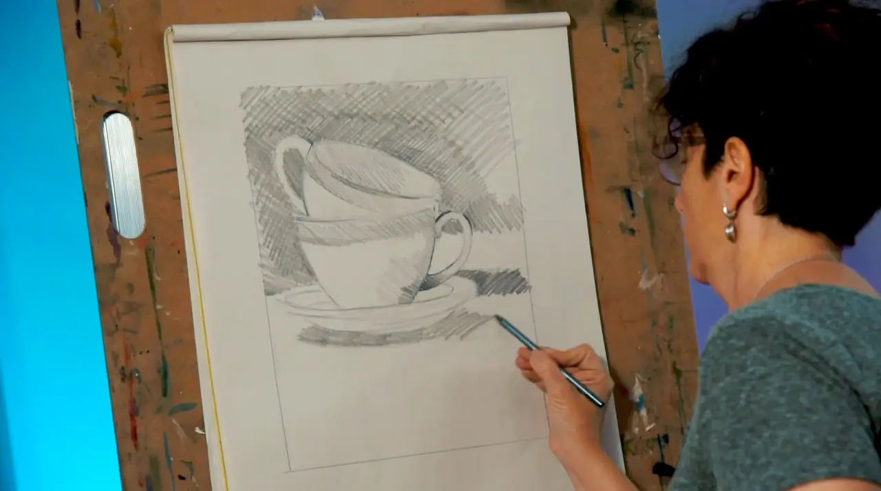 Artist drawing teacups from observation on a drawing board