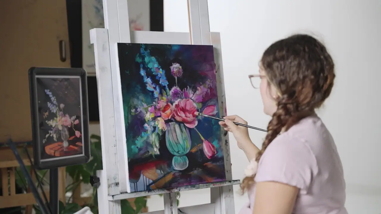 Artist painting a bouquet of mixed flowers in a green vase