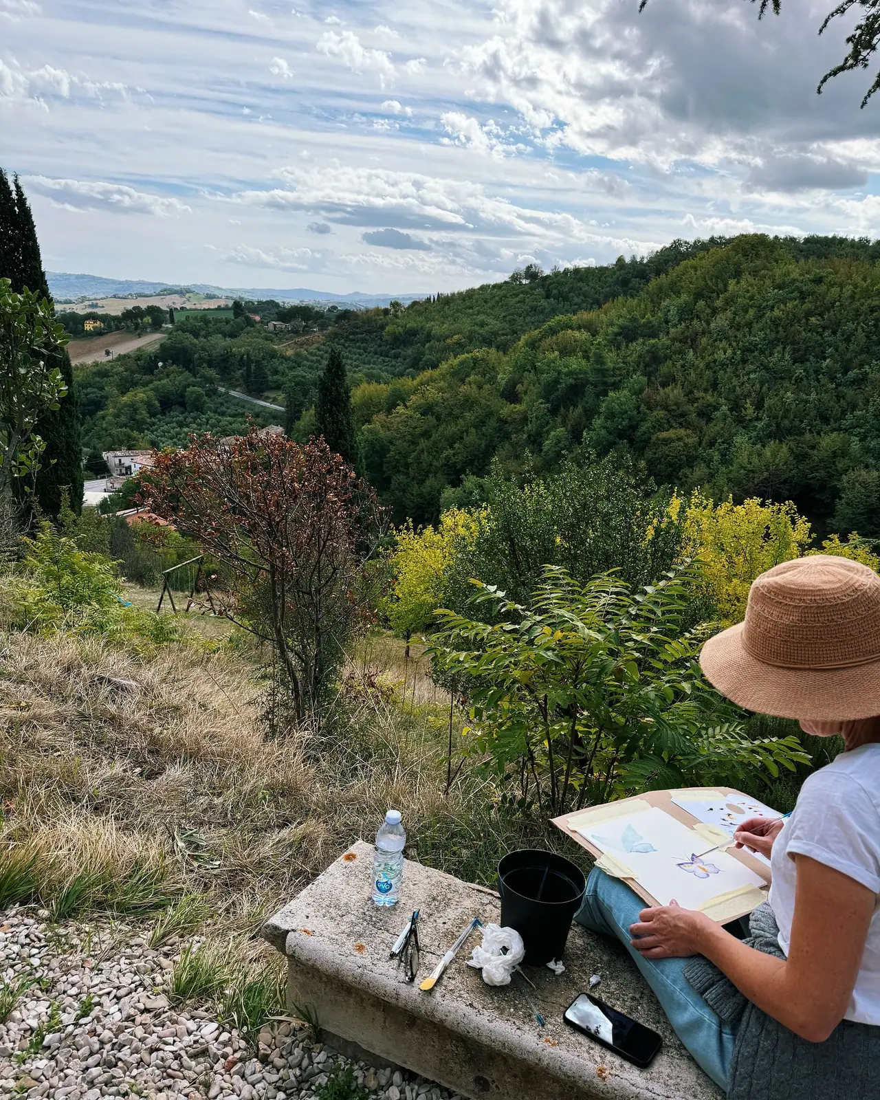 Artists working together with paints and brushes at an Italy art retreat