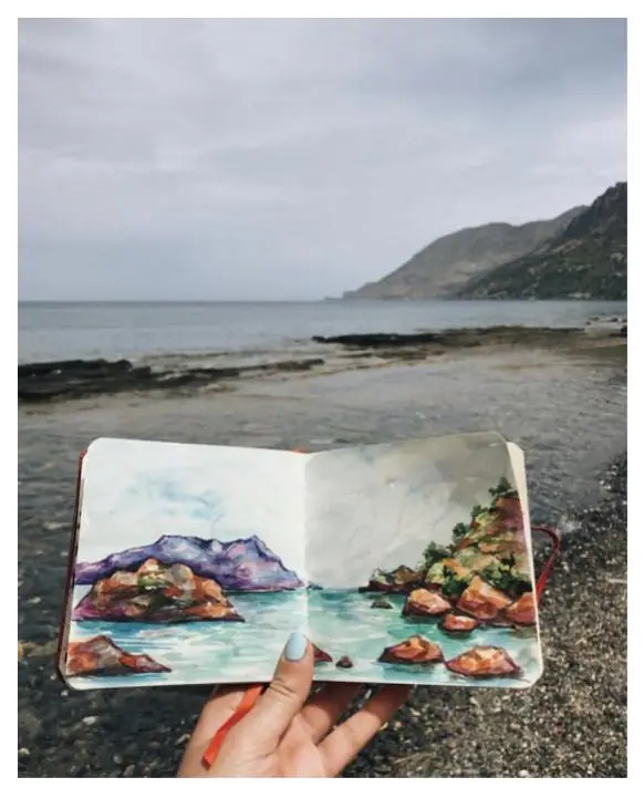Esther Franchuk painting a scene she observed while traveling