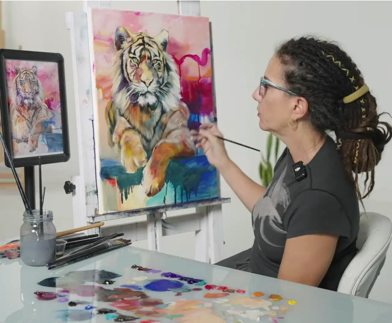Artist refining a tiger painting with translucent oil layers for glow