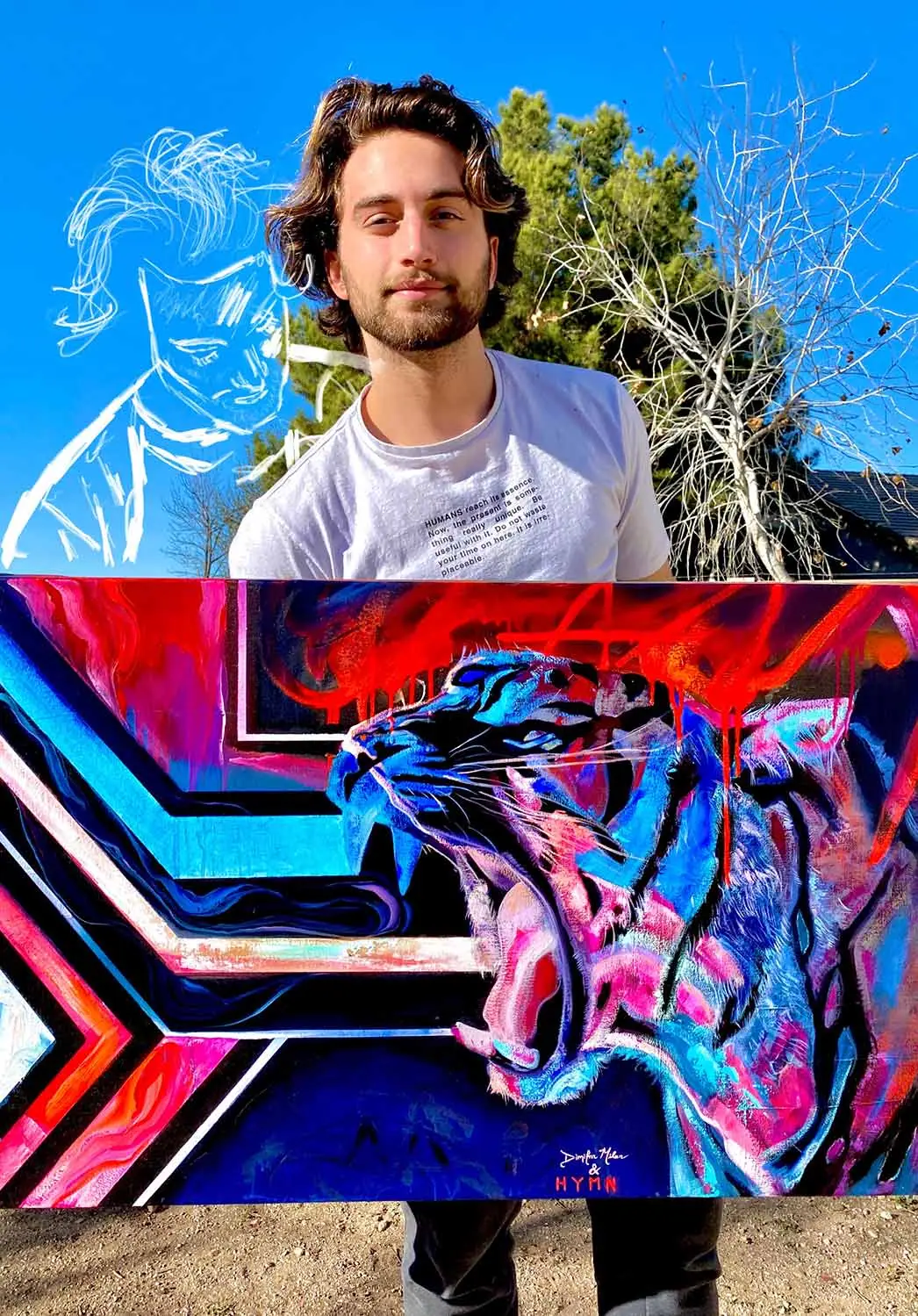 Artist holding a tiger painting in blue, red, and pink, ready to be photographed