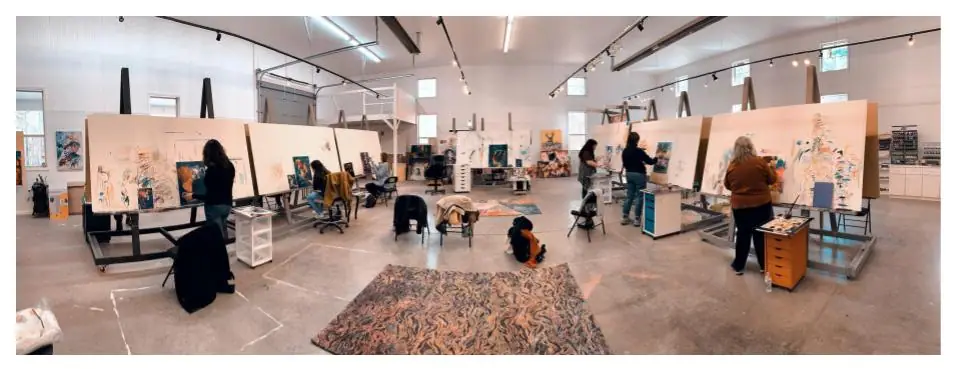 Students at Milan Art Institute painting on large standing easels in a studio
