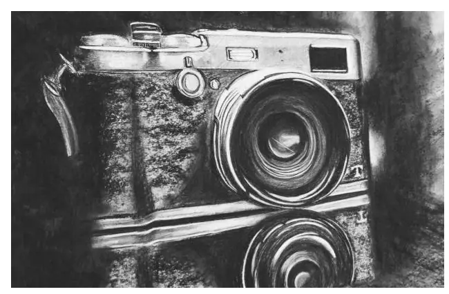 Subtractive charcoal drawing of a camera with light erased out of a dark charcoal ground