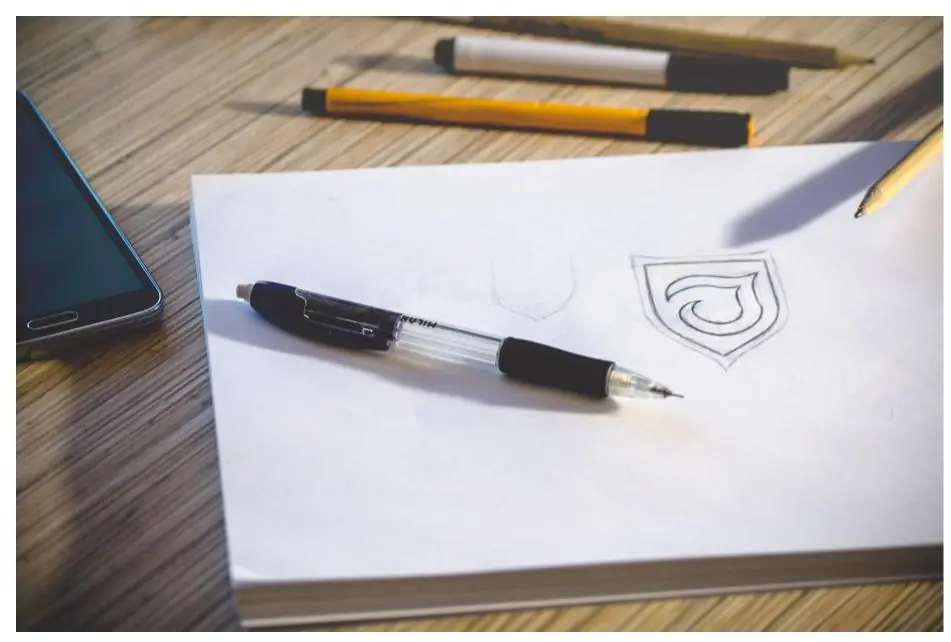 An illustrator's open sketchbook filled with rough idea sketches and design notes