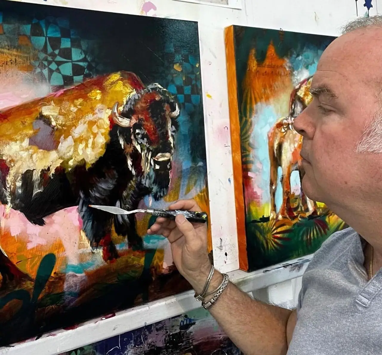 John Milan drawing fine lines into wet paint with the edge of a palette knife