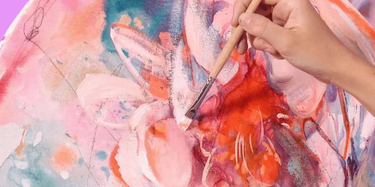 Artist painting white highlights onto a pink flower painting